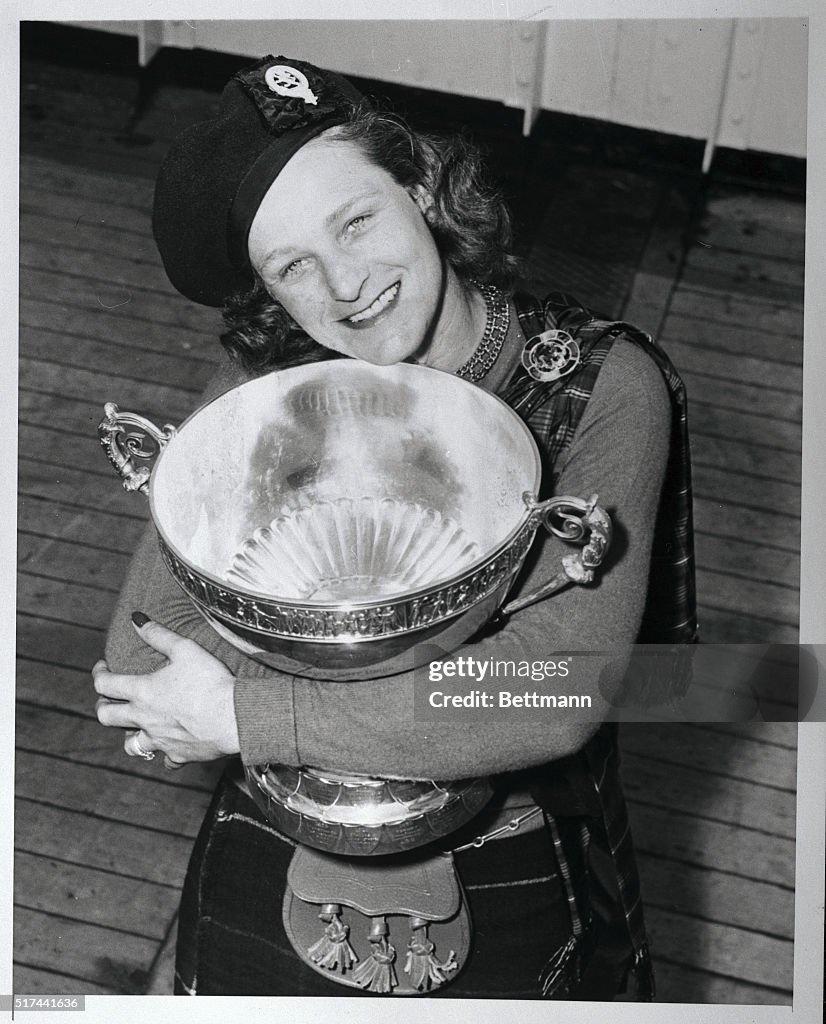 Babe Didrikson Hugging Golf Trophy