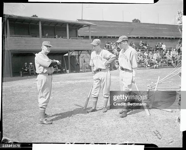 Casey Stengel with bat is shown instructing Elburt Fletcher and Joe Walsh, , with bat, .