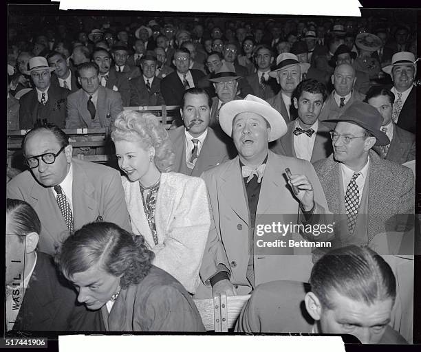 When Joe Louis and Billy Conn fought in the Yankee Stadium June 19 for the heavyweight crown, film player Jack Oakie was at the ringside with a cigar.