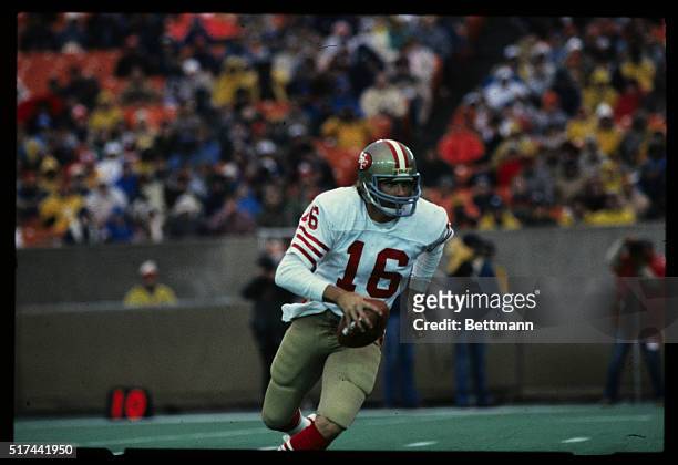 San Francisco 49ers' quarterback Joe Montana is shown running with the football during a game against the Chicago Bears.