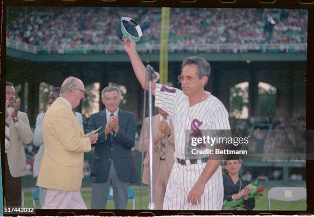 Chicago, Illinois: Former White Sox shortstop Luis Aparicio waves to a cheering crowd during ceremonies at Comskey Park, August 14th, to retire...