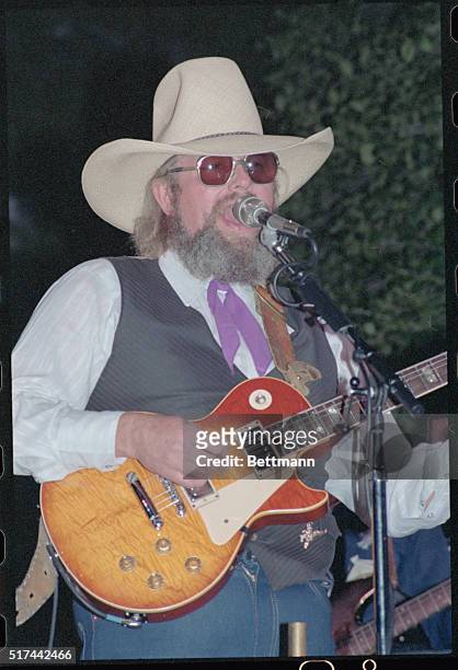 Nashville, Tennessee: Charlie Daniels, country western pop musician, playing guitar in concert in Nashville.