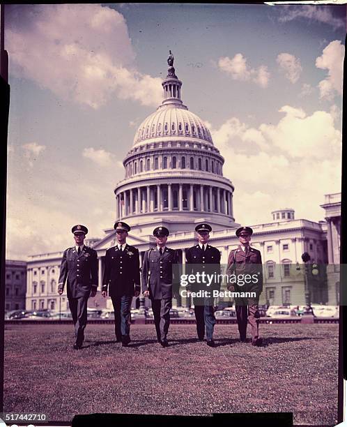 These are uniforms currently being worn by men and women of the U. S. Army. Left to right are Capt. Joseph B. Love, of Phoenix, Arizona wearing army...