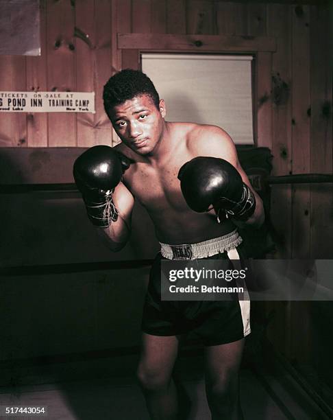 Floyd Patterson with his gloves on in the fighting pose.