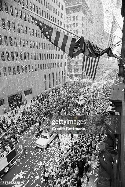 New York, NY- Apollo 11 astronauts Michael Collins, Buzz Aldrin and Neil Armstrong wave to cheering masses in office buildings during a ticker-tape...