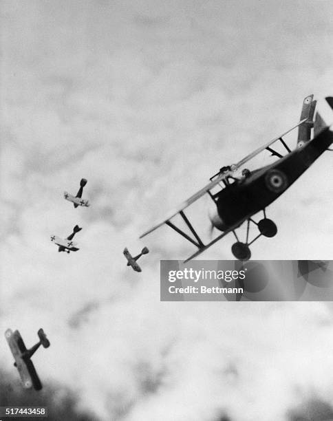 British Sopwith Camel in battle with German biplanes during World War I.