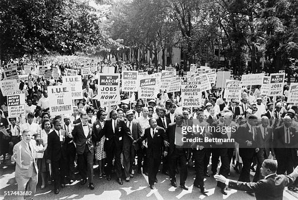 Washington, D.C.- Leaders of the March on Washington lock arms and put hands together as they move along Constitution Avenue here Aug. 28. A. Philip...