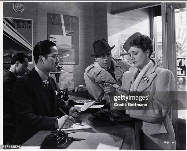 Keye Luke, Humphrey Bogart, and Mary Astor in a scene from the 1942 Warner Brothers First National film "Across the Pacific." Bogart and Astor are...