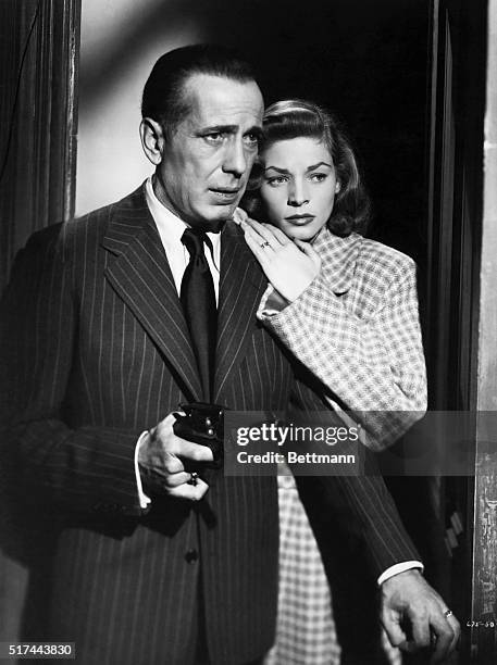 Humphrey Bogart and Lauren Bacall in a scene from the 1946 Warner Brothers film "The Big Sleep." The couple are shown entering a room, with Bogart...