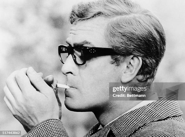 London, England- Michael Caine, espionage agent, keeps a house across the street under constant surveillance. "The Ipcress File," a suspense drama of...