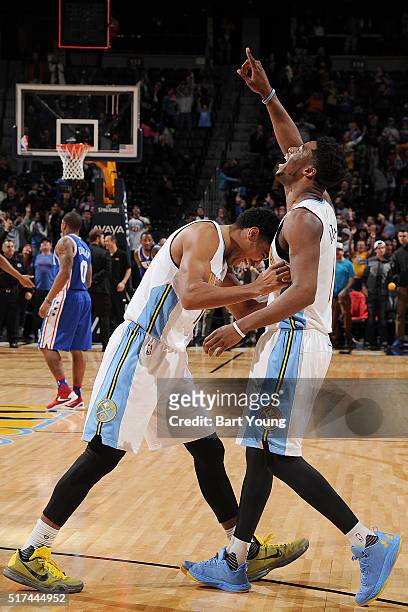 Emmanuel Mudiay of the Denver Nuggets celebrates with his teammates after hitting the game winning three point shot against the Philadelphia 76ers on...