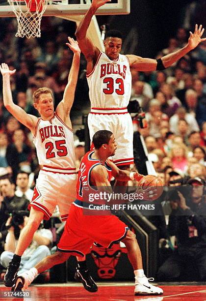 Steve Kerr and Scottie Pippen of the Chicago Bulls try to block a pass from Rod Strickland of the Washington Bullets during the first half of their...