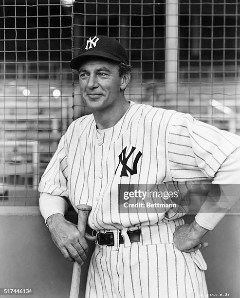 Gary Cooper as Lou Gehrig in a film still from the movie, "Pride of the Yankees," directed by Sam Wood. He wears a Yankees uniform and leans against...