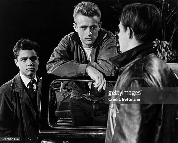 Actors James Dean and Sal Mineo with another actor in a scene from Rebel Without a Cause.