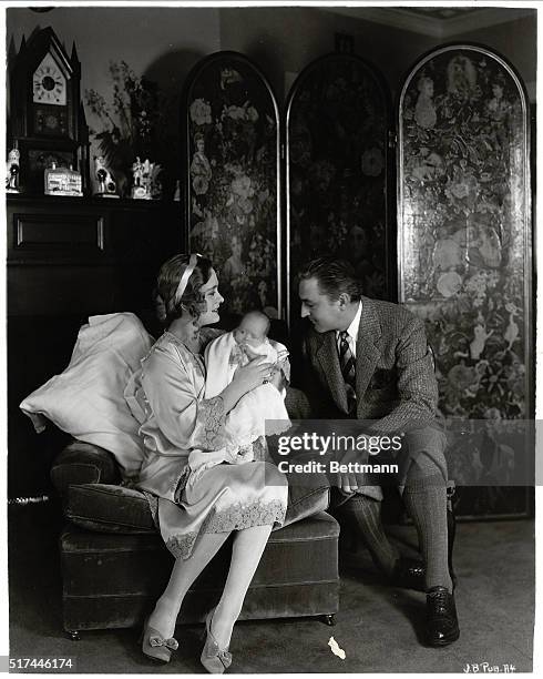 Famed actor John Barrymore , looks lovingly at his wife, actress Dolores Costello, and their new baby, Dolores Ethel Barrymore. They are seated in a...