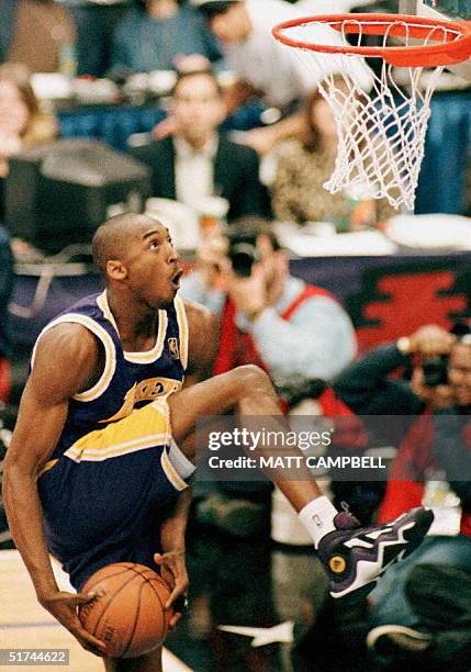 Kobe Bryant, of the Los Angeles Lakers, eyes the basket during the NBA Slam Dunk contest 08 February at Gund Arena in Cleveland, Ohio. Bryant is the...