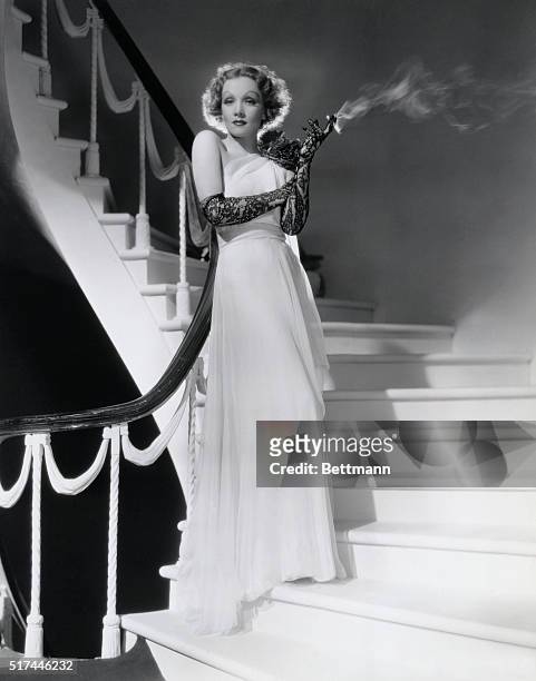 Ca. 1935-ORIGINAL CAPTION READS: An ode to grace is offered by this white chiffon evening gown which Marlene Dietrich, Paramount star of "The Devil...
