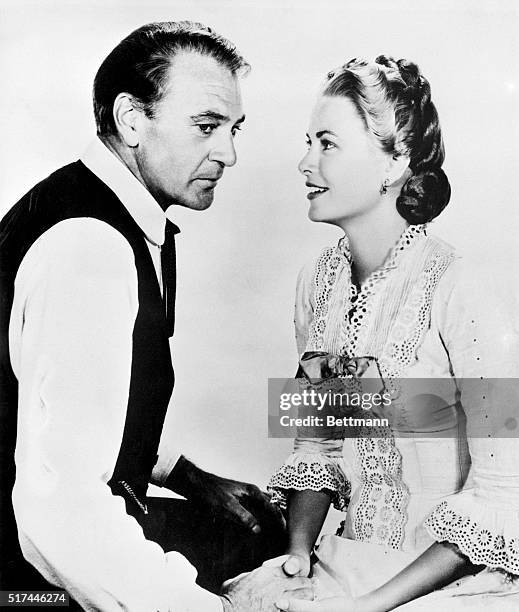 Grace Kelly's love-making in "High Noon" consisted of holding hands with and making eyes at shootin' sheriff Gary Cooper. 1952 film.