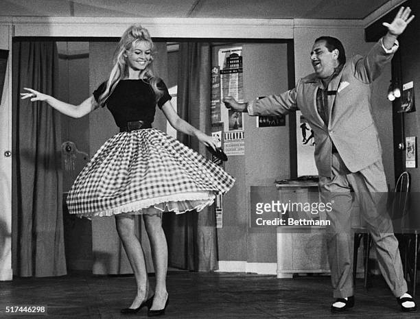 Nice, France- French actress Brigitte Bardot does the cha-cha under the direction of comic Darius Moreno. "B.B." appears in a new movie called "Will...