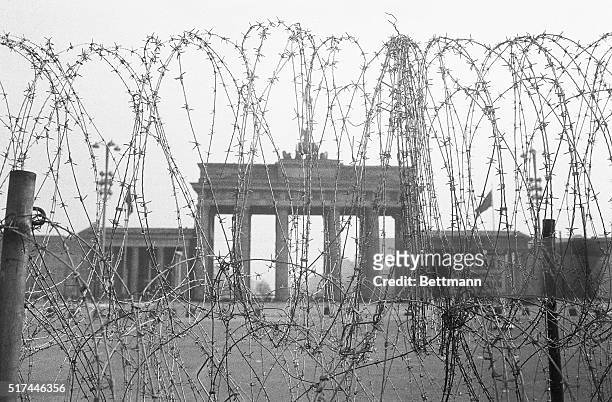 West Berlin, West Germany- Wired shut, the Brandenburg Gate on the dividing line between East and West Berlin looms beyond this barbed wire...