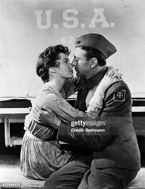 Los Angeles, CA- Just out of sight behind an Army truck, Alvin C. York receives an affectionate greeting from his wife, Gracie, played by Joan...