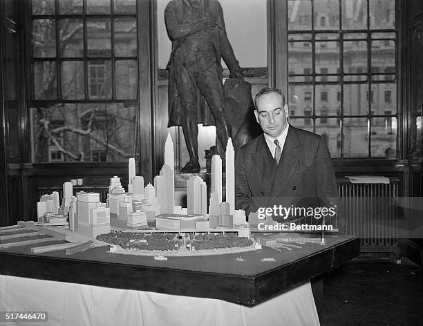 New York, NY- Robert Moses, chairman of the Triborough Bridge Authority, looking at a scale model of the proposed Battery-to-Brooklyn Bridge, at a...