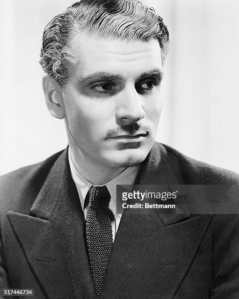 Laurence Olivier, popular British stage and screen star, and member of The Old Vic, is seen as the handsome, dashing Maxim de Winter, Lord of...