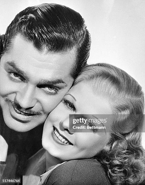 Close-up of Clark Gable and Jean Harlow cheek to cheek.