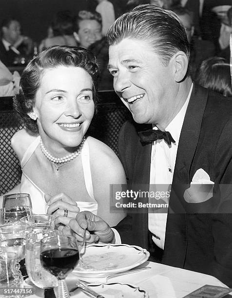 Hollywood, CA-: Ronald Reagan and his wife, the former Nancy Davis, relax at a Hollywood night club in this April file photo. They married in 1952.