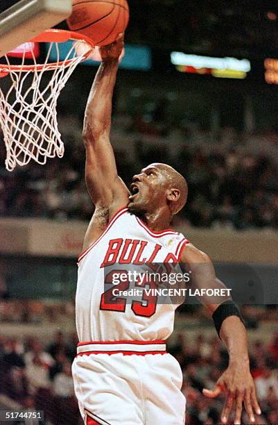 Michael Jordan of the Chicago Bulls slam dunks the ball unchallenged in the first quarter of the Bulls' 15 March game against the Atlanta Hawks at...