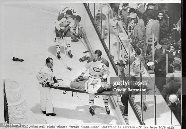 Montreal right winger Bernie "Boom-Boom" Geoffrion, is carried off ice here with damaged ribs, as first casualty of the National Hockey league...