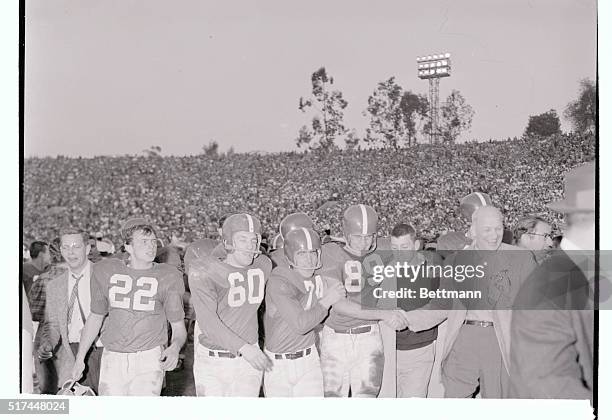 Michigan State end Dave Kaiser is hugged and congratulated by Ron Rickens and fans as he walks off the field after kicking a 31 yard field goal that...