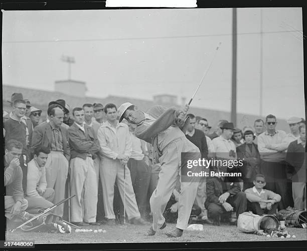 Dr. Carry Middlecoff, runner-up to Julius Bores as the top money winner among golfers for 1955, gets in a warmup round in preparation for the start...