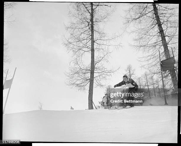 Ossi Reichert, 29 year old brunette Bavarian ski champ, leans into a turn in the Olympic's giant slalom race, which she won with a time of one...