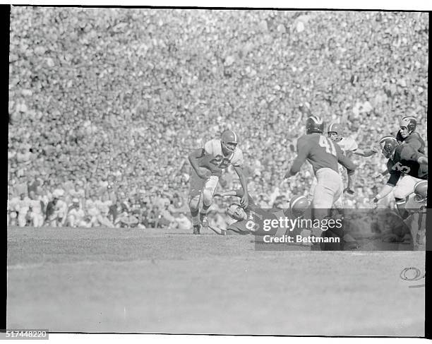Michigan State's Clarence Peaks get by University of Michigan's Ron Kramer only to be stopped for no gain on University of Michigan's 5 yard line in...