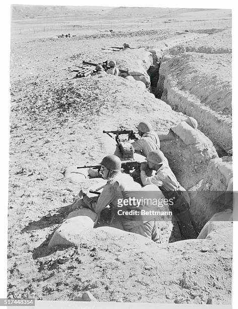 Egyptian troops, in a trench near the frontier, point their weapons toward Israel, April 6th. United Nations officials received a flat warning April...
