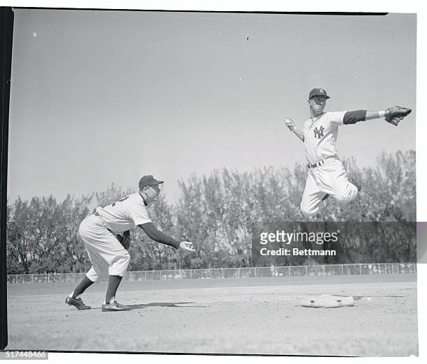 New York Yankees second baseman, Billy Martin, displays flying form befitting mid-season as he completes an imaginary double play at the Yankees...