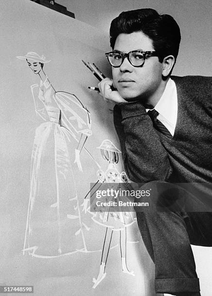 Joe Hong, Neiman Marcus fashion designer, stands before his completed designs of the bridal party dresses for the wedding of Grace Kelly and Prince...