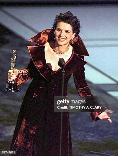 French actress Juliette Binoche holds her Oscar after winning the Best Supporting Actress Oscar for her role in "The English Patient" during the 69th...