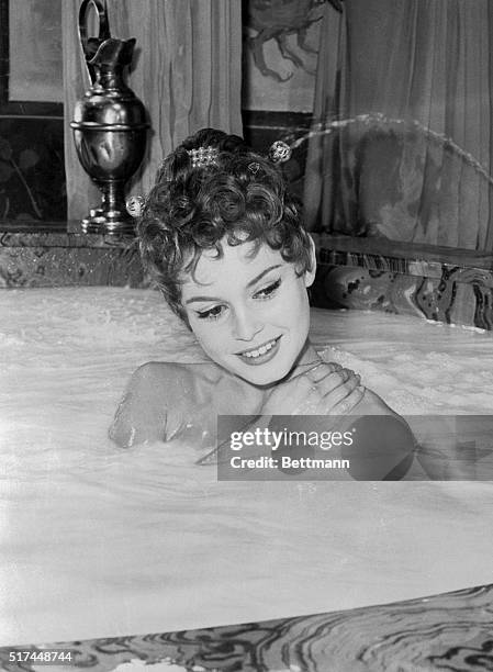 The cream on top of this bathtub of milk is pretty French actress Brigitte Bardot. In a movie being made in Rome, she plays Nero's beautiful wife,...