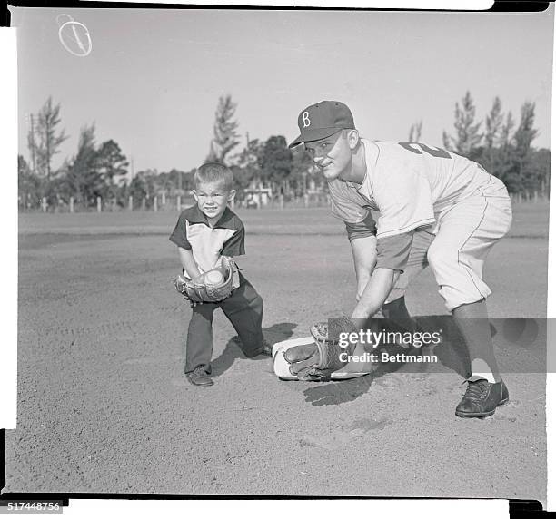 Don Zimmer of the Dodgers gives his 3-year-old son Tommy some professional pointers on how to cover second base. Perhaps Tommy wants to follow in his...