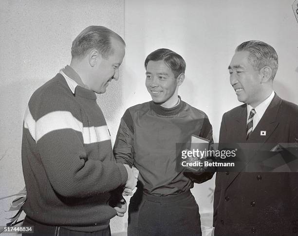 March Hodler , Swiss president of the International Ski Association hands over to Chiharu Igaya, the sensational Japanese skier who attends Dartmouth...
