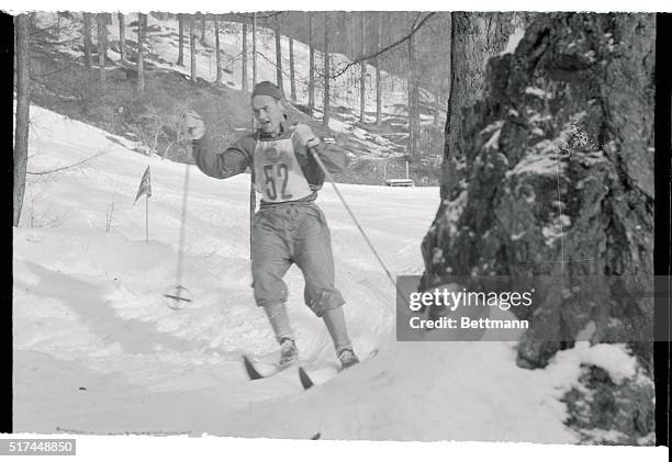 Finnish "ski king" Veikko Hakulinen speeds along during the 30 kilometer cross-country ski race, which he won, in the seventh Winter Olympic Games....
