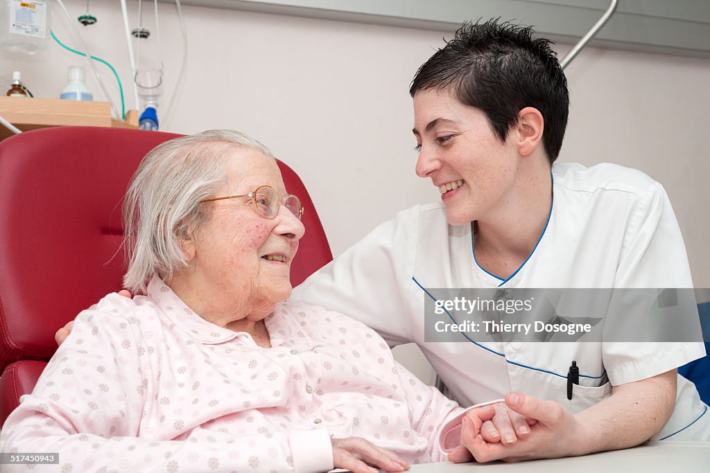 Nurse smiling with senior patient