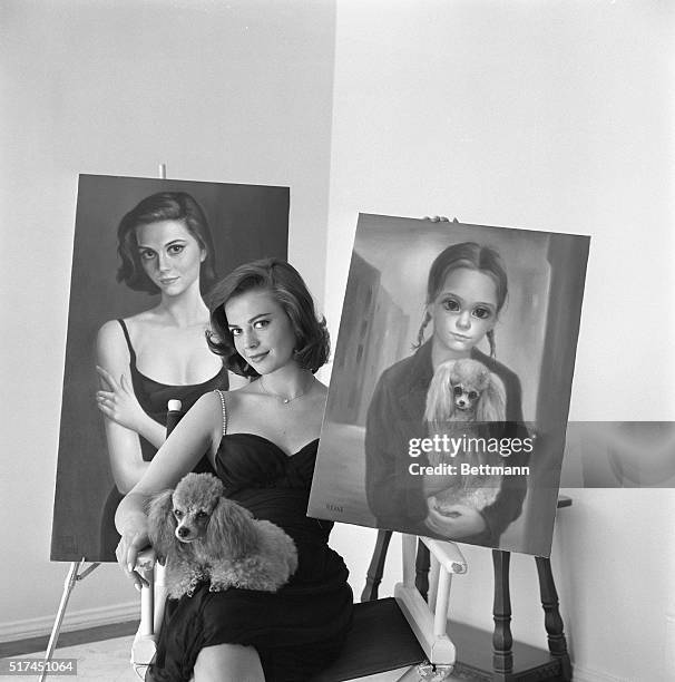 Double Image. Bel Air, California: Natalie Wood displays the two portraits which visitors to her Bel Air, California, home assume were painted many...