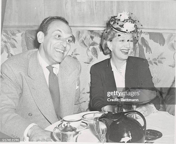 New York, NY: American playwright Moss Hart and English actress Gertrude Lawrence shown dining at the Stork Club in New York.