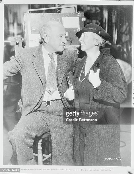 Cecil B. Demille takes a breathing spell during production of The Crusaders at Paramount to chat with Rachel Crothers, authoress and playwright, when...