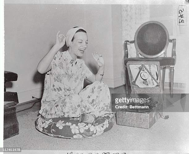 Carmen Miranda is making hey, hey, at her phonograph after clicking in the grand manner in a current Broadway hit. Carmen comes from Brazil and...