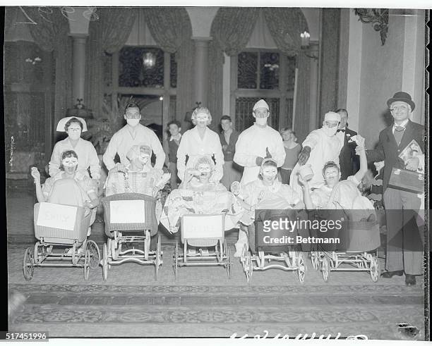Some of the celeb guest came as the Dionne Quintuplets to a Halloween party given by Betty Grable for Jackie Coogan. Standing are Mrs. Eddie Eckles,...