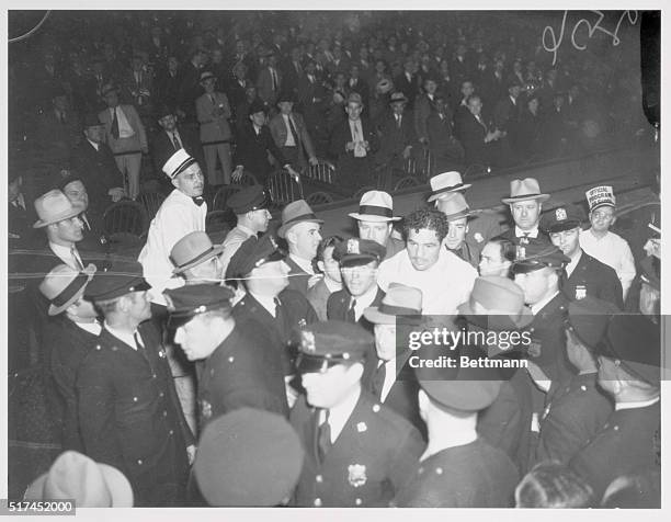 Smiling broadly Max Baer, made the grand entrance into the ring tonight to face Joe Louis before 90,000 spectators. He is seen here with his retinue...